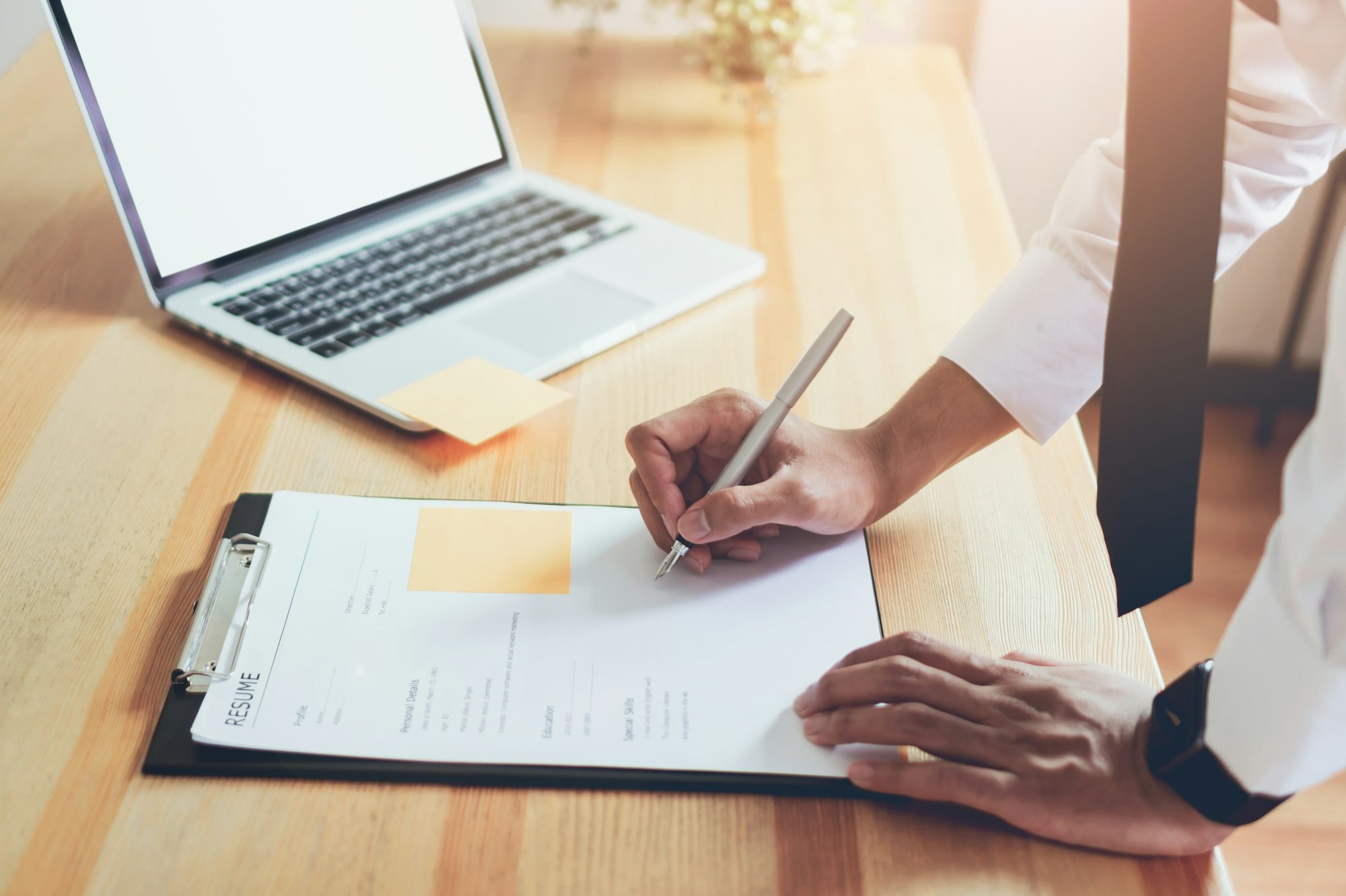 Businessman writing form submit resume employer to review job application